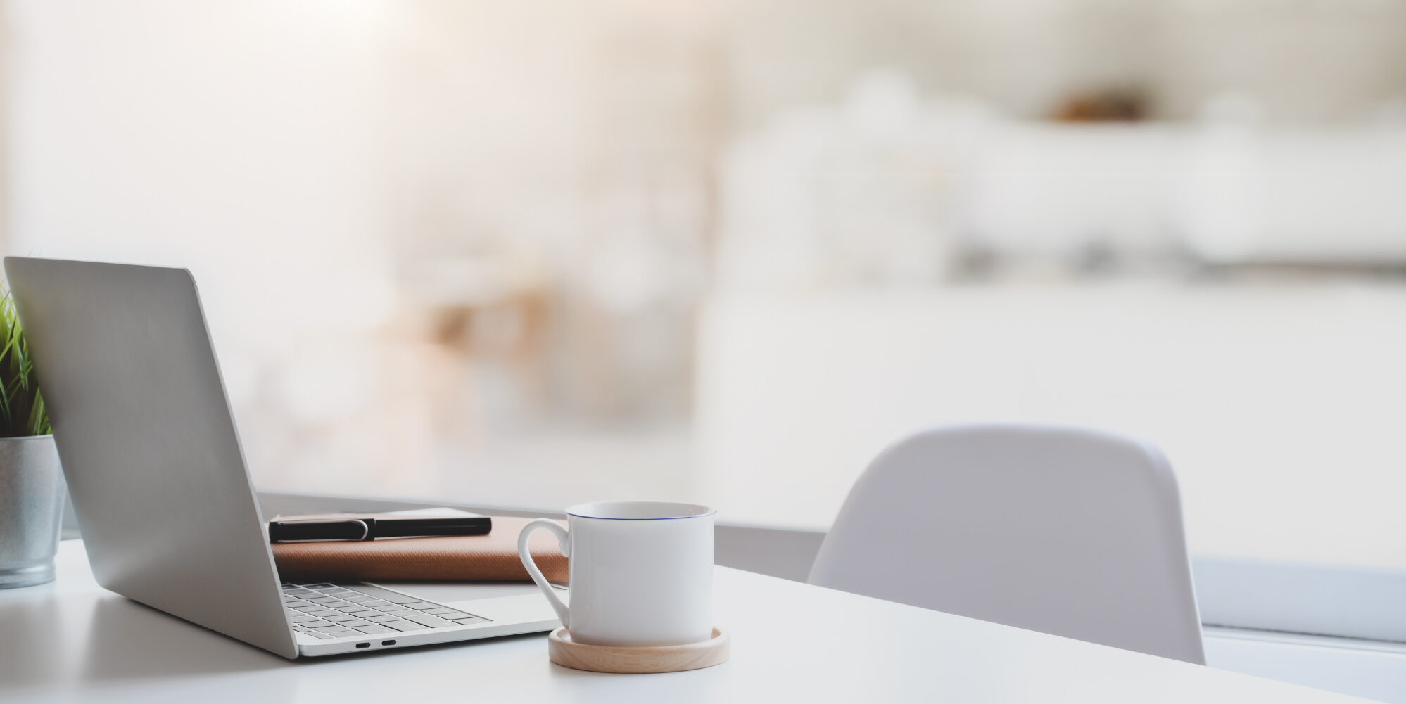 Laptop, coffee cup, and chair